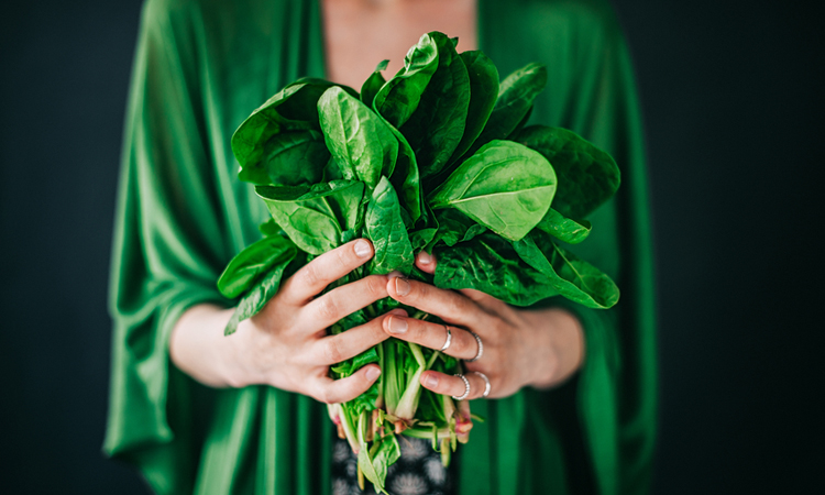 Are-You-Eating-Enough-Veggies holding a bunch of spinach