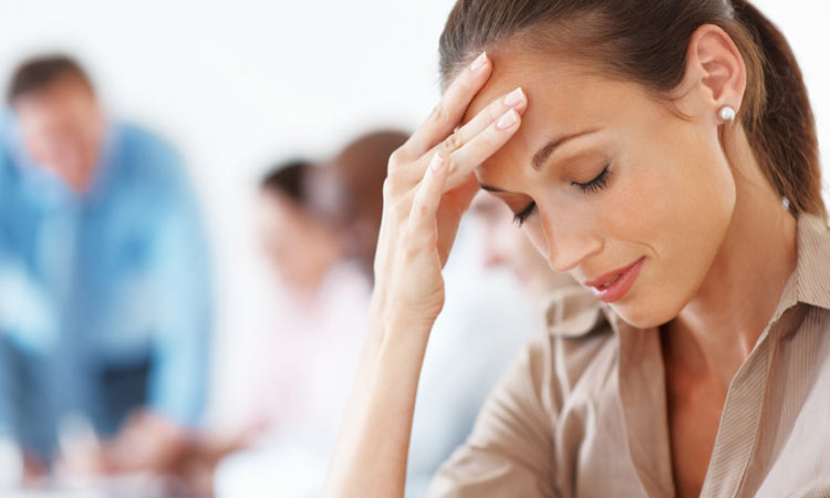 woman holding head with headache